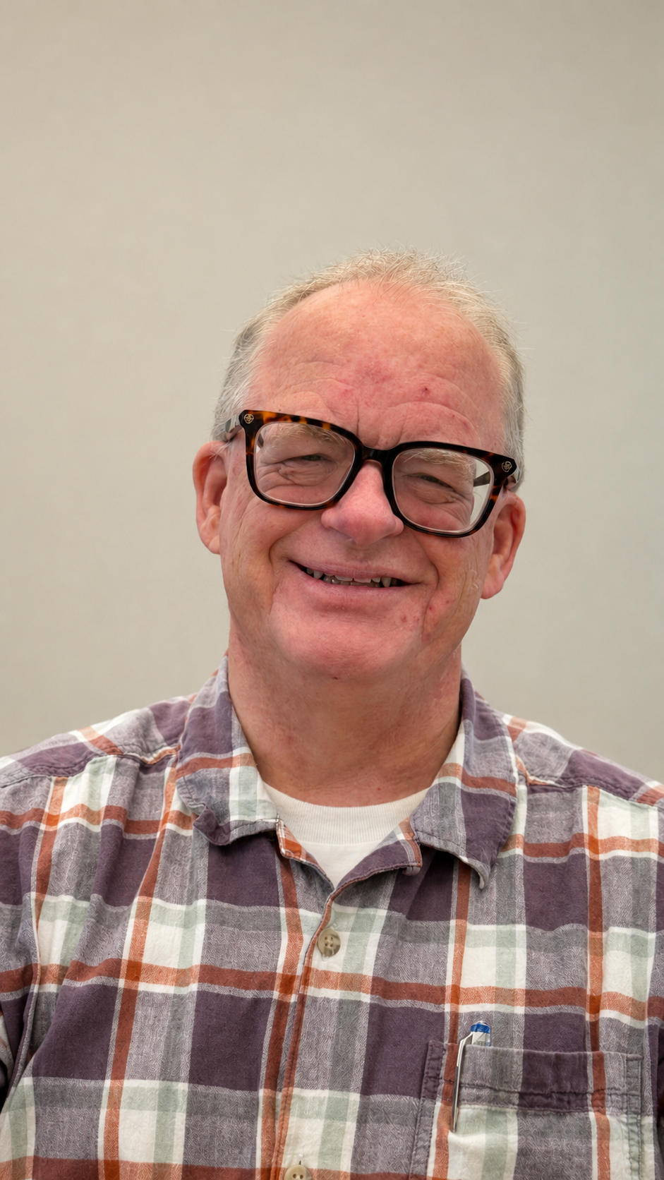 Scott R. Dean wearing a brown plaid shirt